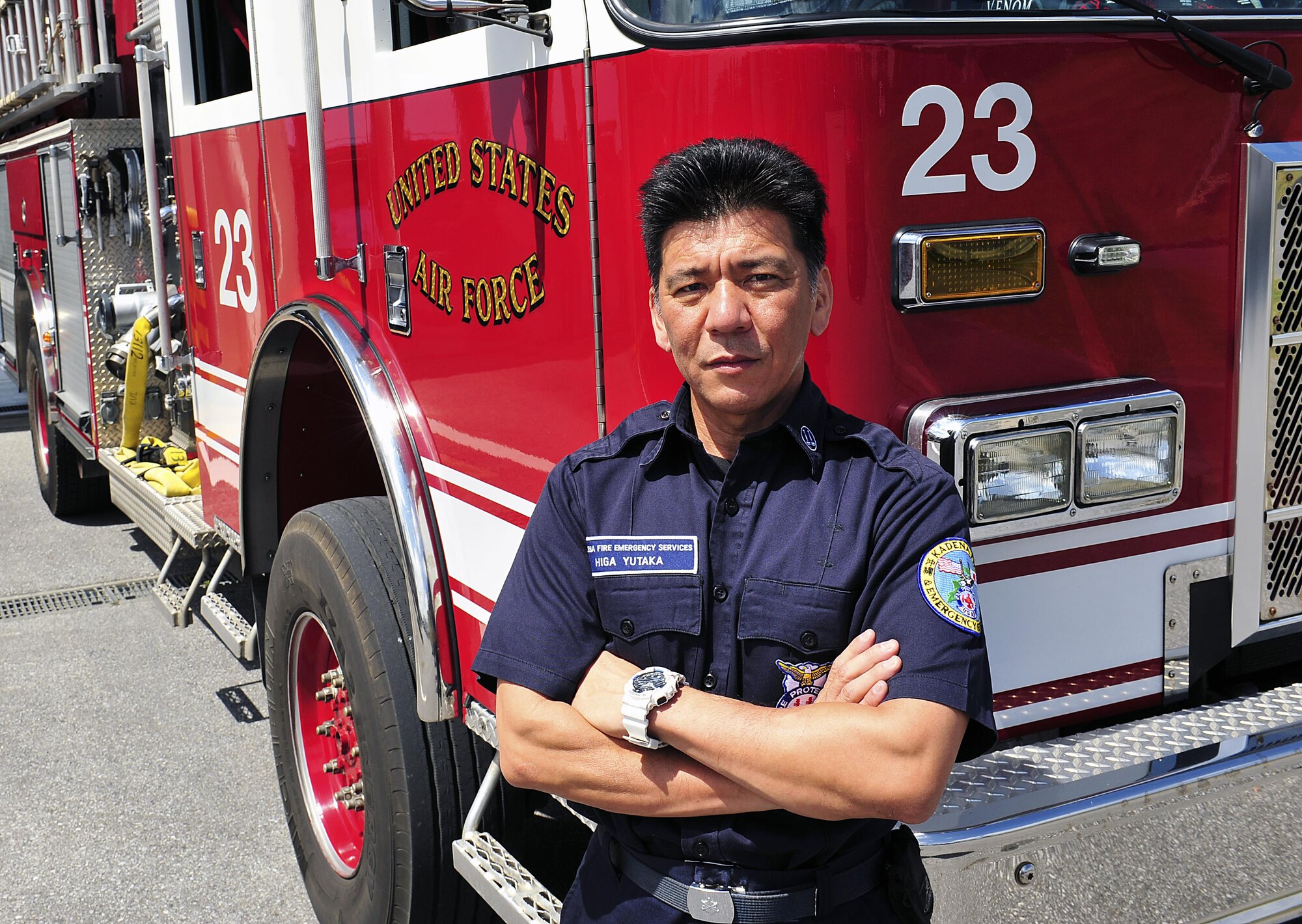 Yutaka Higa, a 18th Civil Engineer Squadron firefighter, poses for a photo in front of a fire truck on Kadena Air Base, Japan, April 2, 2015. Higa, who has been working at the fire department for more than 24 years, recently won the 2014 Air Force Firefighter of the Year award, civilian category, for his day-to-day accomplishments. (U.S. Air Force photo/Naoto Anazawa)