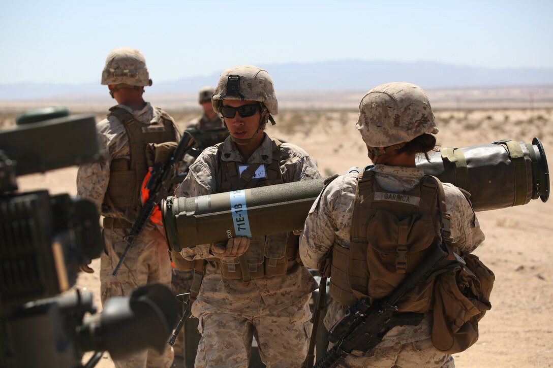Sergeants Emma A. Bringas, left, and Maya Marin C. Garnica, both anti-tank missilemen with Anti-Armor Section, Weapons Company, Ground Combat Element Integrated Task Force, reload an M41A4 Saber missile launcher during a Marine Corps Operational Test and Evaluation Activity assessment at Range 107, Marine Corps Air Ground Combat Center Twentynine Palms, California, April 12, 2015. From October 2014 to July 2015, the GCEITF will conduct individual and collective level skills training in designated ground combat arms occupational specialties in order to facilitate the standards-based assessment of the physical performance of Marines in a simulated operating environment performing specific ground combat arms tasks. (U.S. Marine Corps photo by Cpl. Paul S. Martinez/Released)