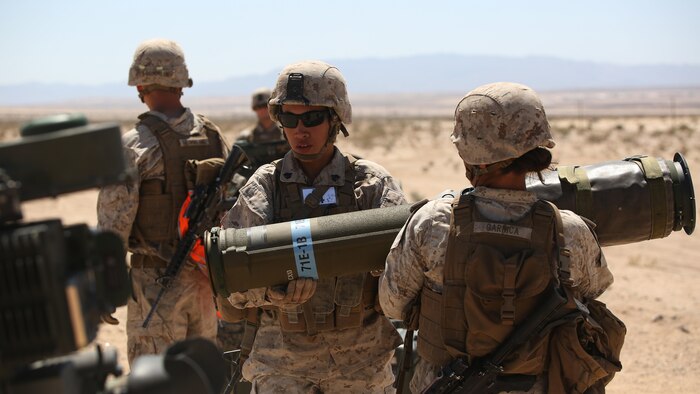 Sergeants Emma A. Bringas, left, and Maya Marin C. Garnica, both anti-tank missilemen with Anti-Armor Section, Weapons Company, Ground Combat Element Integrated Task Force, reload an M41A4 Saber missile launcher during a Marine Corps Operational Test and Evaluation Activity assessment at Range 107, Marine Corps Air Ground Combat Center Twentynine Palms, California, April 12, 2015. From October 2014 to July 2015, the GCEITF will conduct individual and collective level skills training in designated ground combat arms occupational specialties in order to facilitate the standards-based assessment of the physical performance of Marines in a simulated operating environment performing specific ground combat arms tasks.