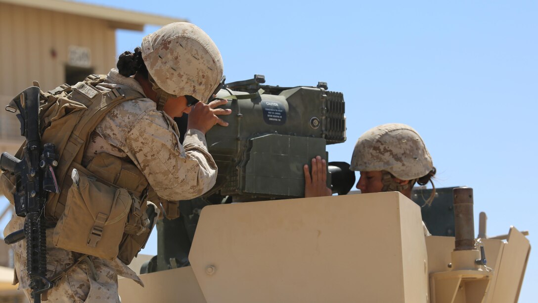 Sergeants Emma A. Bringas, left, and Maya Marin C. Garnica, both anti-tank missilemen with Anti-Armor Section, Weapons Company, Ground Combat Element Integrated Task Force, secure an M41A4 Saber missile launcher atop a Humvee during a Marine Corps Operational Test and Evaluation Activity assessment at Range 107, Marine Corps Air Ground Combat Center Twentynine Palms, California, April 12, 2015. From October 2014 to July 2015, the GCEITF will conduct individual and collective level skills training in designated ground combat arms occupational specialties in order to facilitate the standards-based assessment of the physical performance of Marines in a simulated operating environment performing specific ground combat arms tasks. 