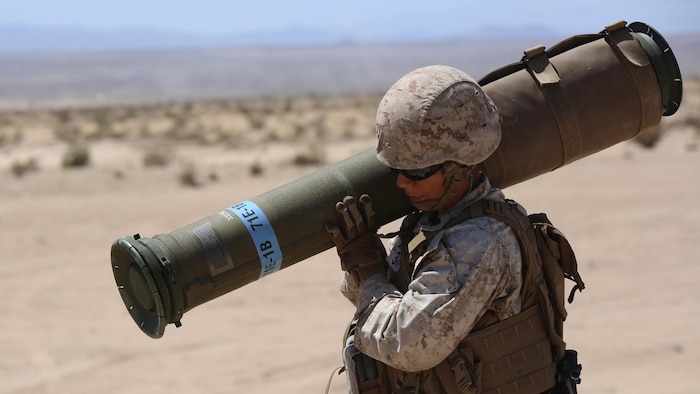 Sgt. Maya Marin C. Garnica, anti-tank missileman, Anti-Armor Section, Weapons Company, Ground Combat Element Integrated Task Force, carries a tube-launched, optically-tracked, wire-guided missile to the firing line during a Marine Corps Operational Test and Evaluation Activity assessment at Range 107, Marine Corps Air Ground Combat Center Twentynine Palms, California, April 12, 2015. From October 2014 to July 2015, the GCEITF will conduct individual and collective level skills training in designated ground combat arms occupational specialties in order to facilitate the standards-based assessment of the physical performance of Marines in a simulated operating environment performing specific ground combat arms tasks. 