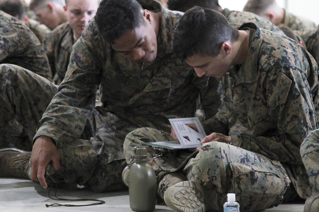 MARINE CORPS BASE CAMP PENDLETON, Calif. – Second Lt. Colleen Brown, a California State University of Long Beach graduate, explains the M16-A4 service rifle to United States Marine Corps officer candidates from Orange County, Los Angeles and San Diego during Officer Candidate School Prep aboard the installation April 11. Candidates spent three days on Pendleton participating in hikes, classes and obstacle courses. (U.S. Marine Corps photo by Sgt. Vanessa Jimenez)