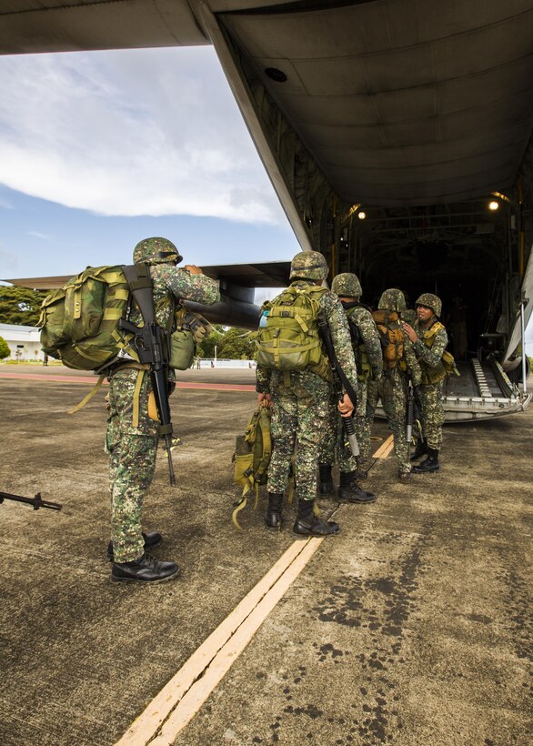 Philippine Marines, with 3rd Marine Brigade, Battalion Landing Team 4, load onto a United States Marine Corps C-130 Hercules, with Marine Aerial Refueler Transport Squadron 152 on Antonio Bautista Air Base, in Puerto Princesa, Republic of the Philippines, during exercise Balikatan 2015, April 15. The Philippine Marines used the C-130 as transport from Puerto Princesa to Subic, where they will train shoulder to shoulder with Marines from III Marine Expeditionary Force and increase interoperability between partnering nations.