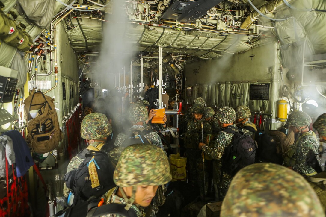 Philippine Marines, with 3rd Marine Brigade, Battalion Landing Team 4, load supplies onto a United States Marine Corps C-130 Hercules, with Marine Aerial Refueler Transport Squadron 152, on Antonio Bautista Air Base, in Puerto Princesa, Republic of the Philippines, during exercise Balikatan 2015, April 15. The Philippine Marines used the C-130 as transport from Puerto Princesa to Subic, where they will train shoulder to shoulder with Marines from III Marine Expeditionary Force and increase interoperability between partnering nations.