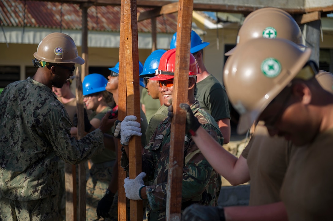 Armed Forces of the Philippines Army Sgt. Michael Bofill, assigned to the 552nd Engineer Construction Battalion, holds a measurement stick to help level select aggregate for a concrete pad along with U.S. Marine engineers, assigned to the 9th Engineer Support Battalion, and U.S. Navy Seabees from Naval Mobile Construction Battalion 5, at Don Joaquin Artuz Memorial Elementary School in Tapaz, Philippines, during Balikatan 2015, April 11. The engineers are part of the Joint Civil-Military Operations Task Force on the island of Panay constructing two classrooms at the school. Balikatan, which means “shoulder to shoulder” in Filipino, is an annual bilateral training exercise aimed at improving the ability of Philippine and U.S. military forces to work together during planning, contingency, humanitarian assistance and disaster relief operations. 