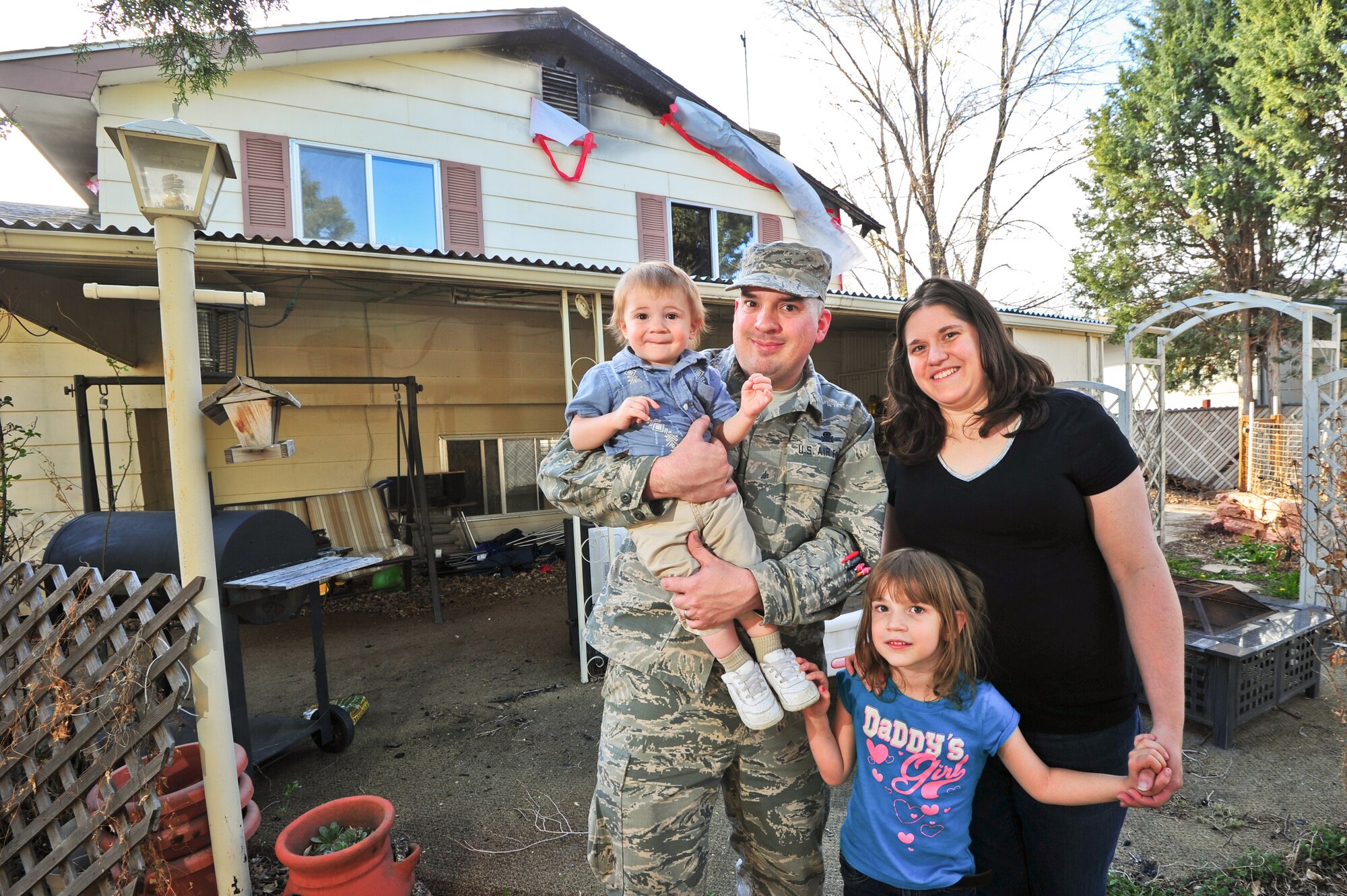 Despite all the problems that follow a house fire, Air Force Reserve Master Sgt. David Hodge, his son David, wife Heather and daughter Caitlyn are still able to smile April 14, 2015, in Colorado Springs, Colo. Hodge is assigned to the 6th Space Operations Squadron.
(U.S. Air Force photo/Tech. Sgt. Nicholas B. Ontiveros)
