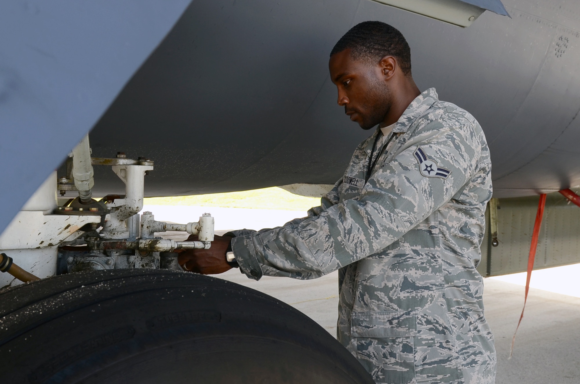 Airman 1st Class Iseral McDowell, 36th Expeditionary Aircraft Maintenance Squadron hydraulic systems apprentice, examines steering actuator on a B-52H Stratofortress at Andersen Air Force Base, Guam, April 7, 2015. McDowell is deployed here with his wife, Airman 1st Class Ashley McDowell, 20th Expeditionary Bomb Squadron combat crew communications apprentice, from Barksdale AFB, La. (U.S. Air Force photo by Airman 1st Class Alexa Ann Henderson/Released)