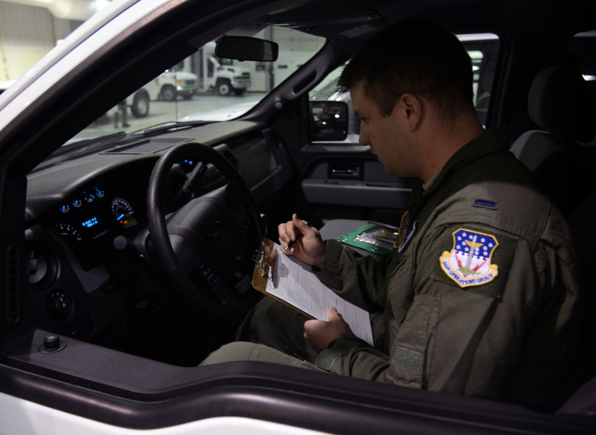 1st Lt. Will Coley, 10th Missile Squadron deputy flight commander, inspects a vehicle March 16, 2015, at Malmstrom Air Force Base, Mont. Coley inspects each vehicle he takes to the missile field prior to his departure. (U.S. Air Force photo/ Airman 1st Class Dillon Johnston)