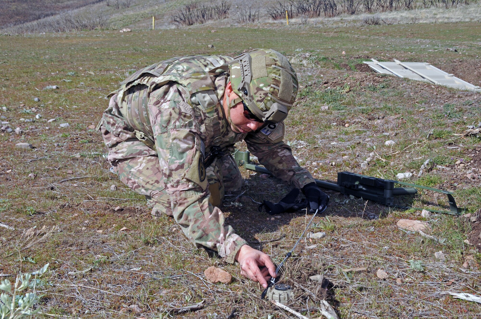 Master Sgt. Timothy Edwards, an explosive ordnance technician with the Utah Air National Guard's 151st Civil Engineering Squadron, prepares to move a simulated landmine at the Improvised Explosive Device Training Lane at Camp Williams, Utah on April 9, 2015. The training scenario conducted with the Utah Army National Guard's 1457th Engineer Battalion was followed by a discussion with Moroccan State Partners. (Air National Guard photo by Staff Sgt. Annie Edwards/RELEASED)