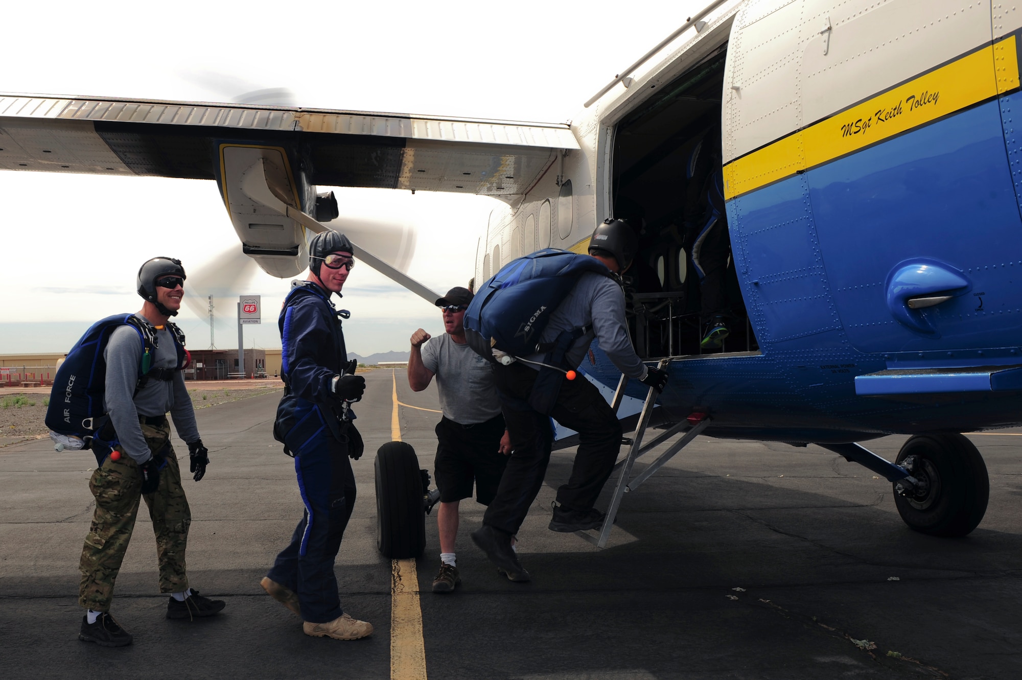 U.S. Air Force Senior Airman Matthew Shoup, 355th Civil Engineering Squadron explosive ordnance disposal apprentice, gives a thumbs up as he and Airmen from Davis-Monthan Air Force Base board an aircraft for a tandem skydive at Desert Skydiving Center in Buckeye, Ariz., April 2, 2015. Twenty-five Airmen from D-M were selected to tandem skydive with members of the 98th Flight Training Squadron. (U.S. Air Force photo by Airman 1st Class Chris Drzazgowski/Released)