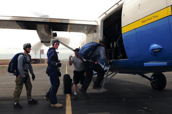 U.S. Air Force Senior Airman Matthew Shoup, 355th Civil Engineering Squadron explosive ordnance disposal apprentice, gives a thumbs up as he and Airmen from Davis-Monthan Air Force Base board an aircraft for a tandem skydive at Desert Skydiving Center in Buckeye, Ariz., April 2, 2015. Twenty-five Airmen from D-M were selected to tandem skydive with members of the 98th Flight Training Squadron. (U.S. Air Force photo by Airman 1st Class Chris Drzazgowski/Released)