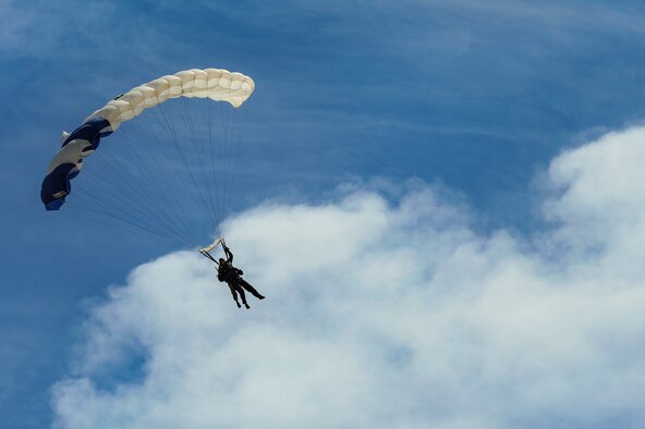 U.S. Air Force Senior Airman Deondre Sanders, 355th Fighter Wing administrative specialist, and Tech. Sgt. William Howell, 98th Flying Training Squadron aircrew flight equipment specialist, parachute to the airfield at Desert Skydiving Center in Buckeye, Ariz., April 2, 2015. Sanders was one of 25 Airmen from Davis-Monthan Air Force Base to be selected for a tandem skydiving event hosted by members of the 98th FTS. (U.S. Air Force photo by Airman 1st Class Chris Drzazgowski/Released)