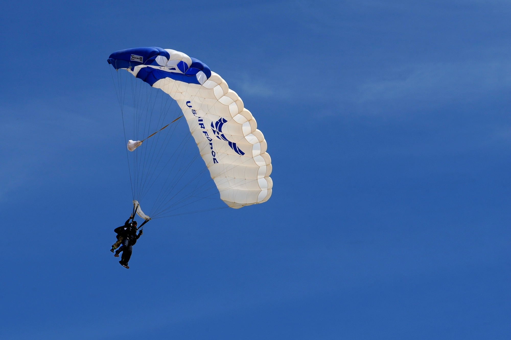 U.S. Air Force Senior Airman Deondre Sanders, 355th Fighter Wing administrative specialist, and Tech. Sgt. William Howell, 98th Flying Training Squadron aircrew flight equipment specialist, descend to the airfield at Desert Skydiving Center in Buckeye, Ariz., April 2, 2015. Sanders was one of 25 Airmen from Davis-Monthan Air Force Base to be selected for a tandem skydiving event hosted by members of the 98th FTS. (U.S. Air Force photo by Airman 1st Class Chris Drzazgowski/Released)