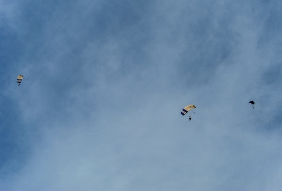 Airmen from Davis-Monthan Air Force Base and parachute instructors from the 98th Flying Training Squadron parachute to the airfield at Desert Skydiving Center in Buckeye, Ariz., April 2, 2015. Instructors from the 98th FTS provided Airmen from Davis-Monthan Air Force Base tandem skydiving as a way to thank D-M for its frequent accommodations in support of the squadron’s mission. (U.S. Air Force photo by Airman 1st Class Chris Drzazgowski/Released)
