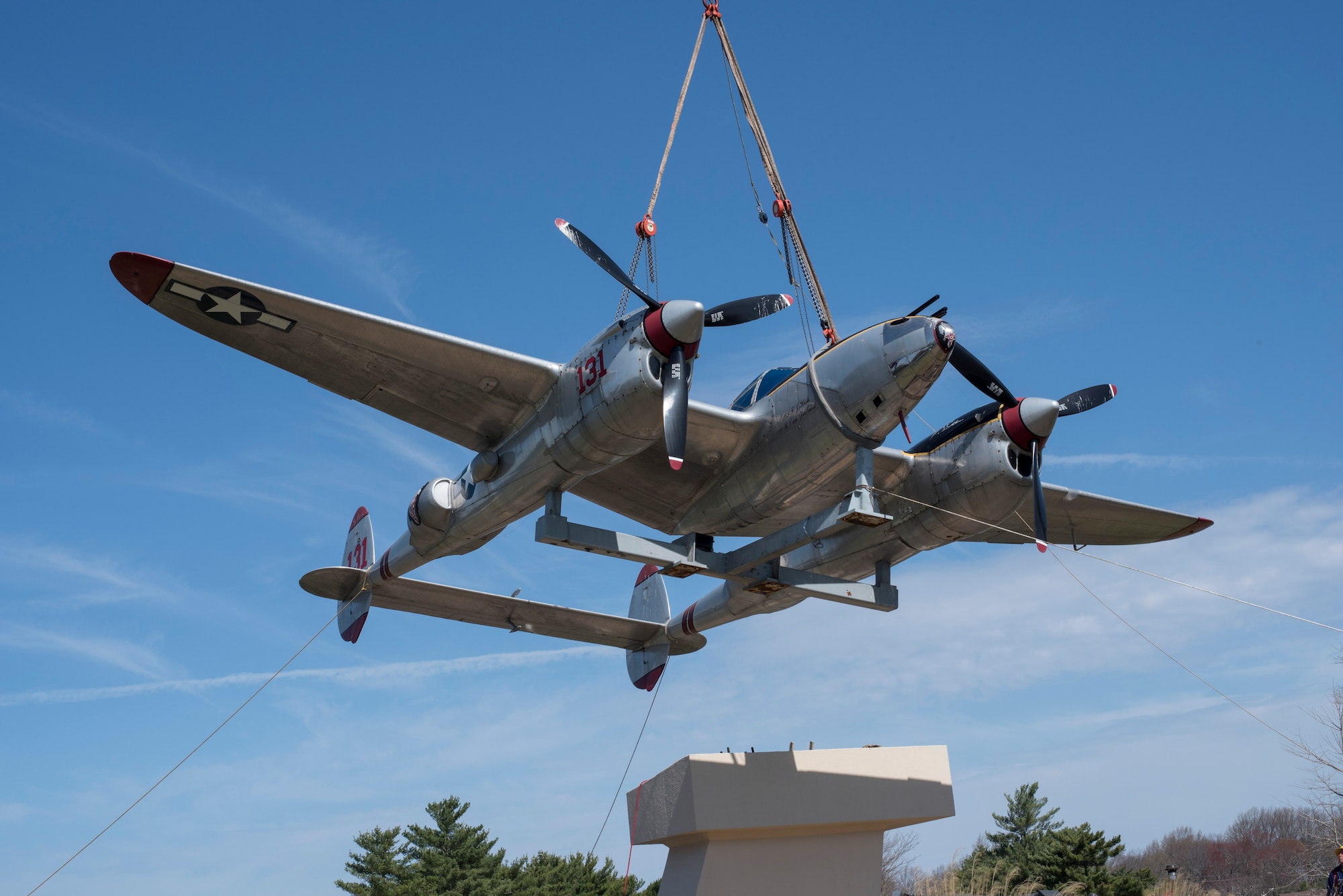The P-38 Lightning Pudgy static display, christened Pudgy, is lifted off its pedestal before being loaded onto a flatbed to be moved to a hangar on Joint Base McGuire-Dix-Lakehurst, N.J., April 13, 2015. Pudgy has been on display at the base since 1981 and is a memorial to Medal of Honor recipient Maj. Thomas B. McGuire, after which the former McGuire Air Force Base was named. (U.S. Air Force photo by Airman 1st Class Tara A. Williamson/Released)