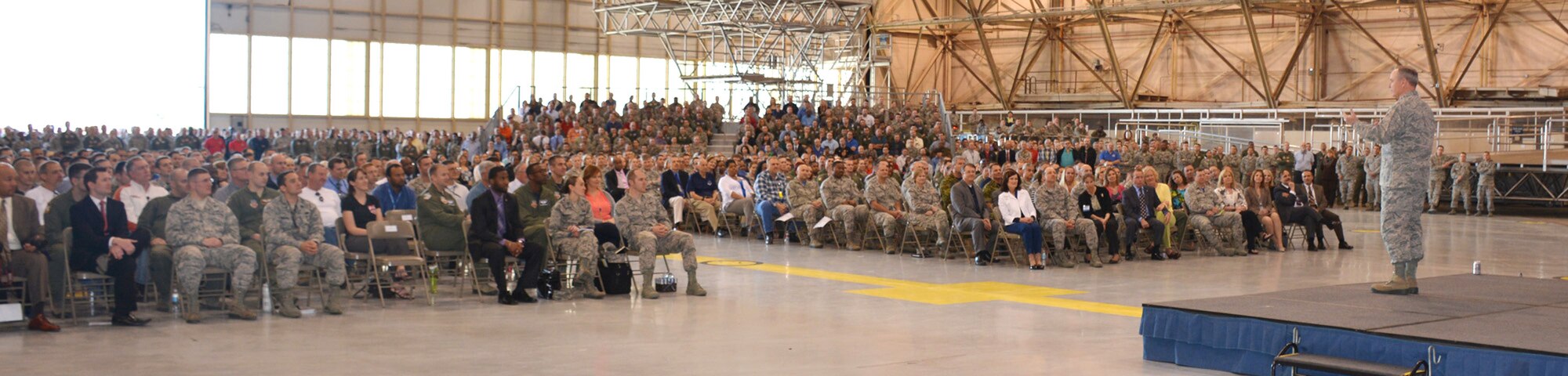 Air Force Chief of Staff Gen. Mark A. Welsh III addresses a standing-room-only crowd of uniformed and civilian Airmen at Tinker Air Force Base during an All-Call April 10 in Bldg. 230, Dock 2. The All-Call was just one of many events attended by General Welsh and his wife, Betty, as part of the couple’s three-day tour of the base. (Air Force photo by Darren D. Heusel)