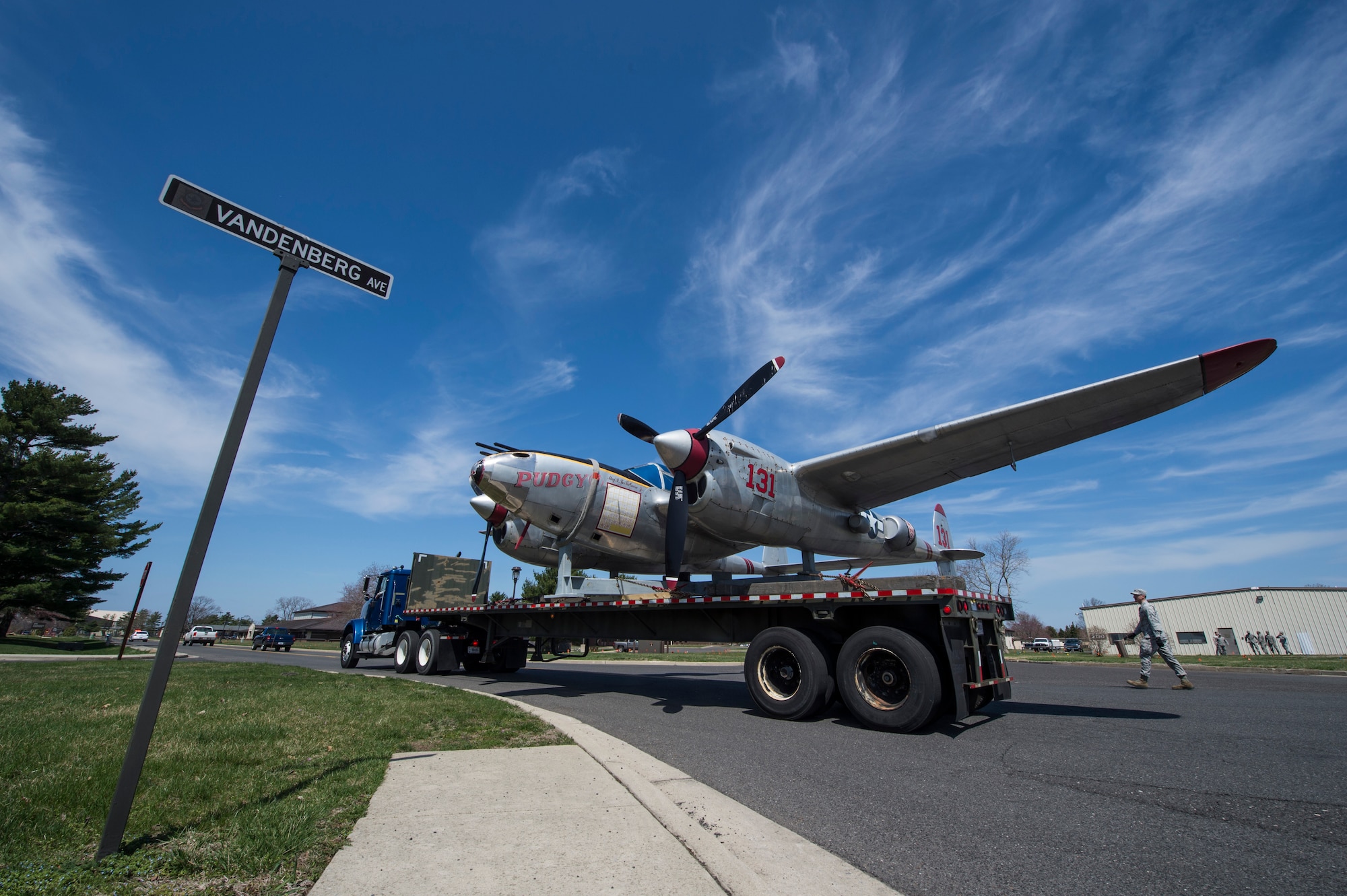 The P-38 Lightning Pudgy static display, christened Pudgy, is transported down Vandenberg Avenue on Joint Base McGuire-Dix-Lakehurst, N.J., April 13, 2015. Pudgy has been on display at the base since 1981 and is a memorial to Medal of Honor recipient Maj. Thomas B. McGuire, after which the former McGuire Air Force Base was named. (U.S. Air Force photo/Staff Sgt. Gustavo Gonzalez/Released)