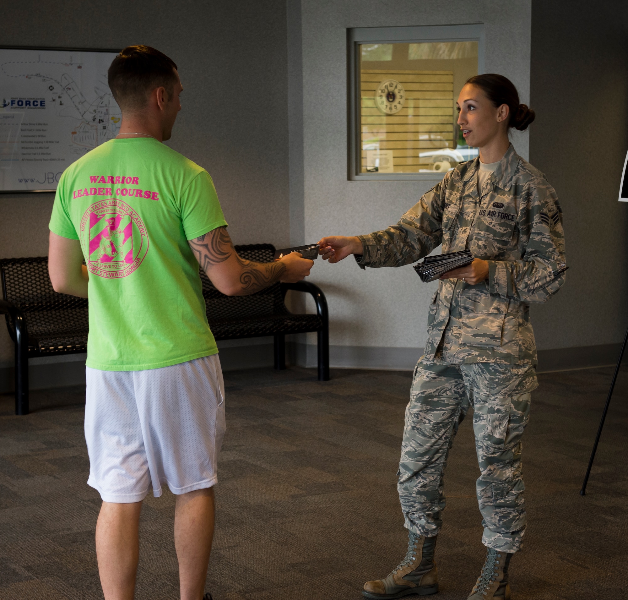 Senior Airman Dana Horn, 628th Communications Squadron emergency actions controller, hands out Holocaust remembrance cards to members of Joint Base Charleston April 16, 2015, at the Fitness Center on Joint Base Charleston, S.C. There were 1,000 total cards given out that day. Each card represented 6,000 people that lost their lives in the Holocaust. (U.S. Air Force photo/Airman 1st Class Clayton Cupit)