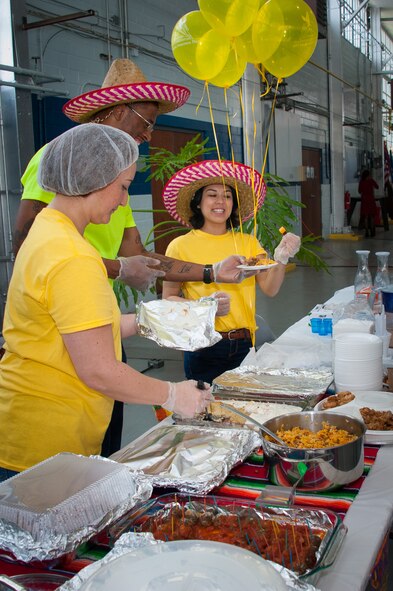 Airmen share native Hispanic food at the Hispanic Heritage table during Cultural Awareness Day, April 10, 2015, at Maxwell Air Force Base, Alabama. Three cultures to include African American, National American Indian and Asian American- Pacific Islander along with several observances were showcased during the event. (U.S. Air Force photo by Melanie Rodgers Cox/Cleared)