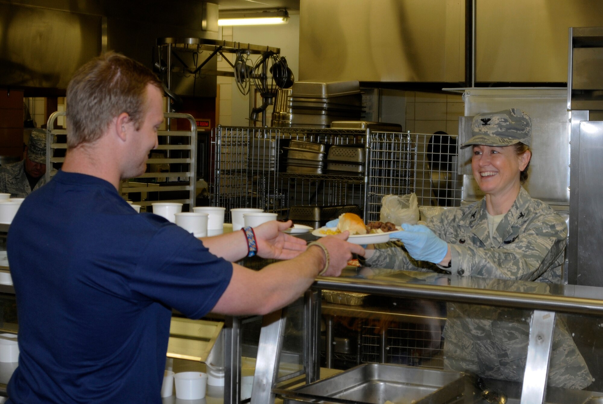 Col. Bobbi Doorenbos, 188th Wing commander, serves lunch to a member of the 188th Student Flight at Ebbing Air National Guard Base’s Citizen Airman Dining Facility April 12, 2015. (U.S. Air National Guard photo by Staff Sgt. Hannah Dickerson/released)