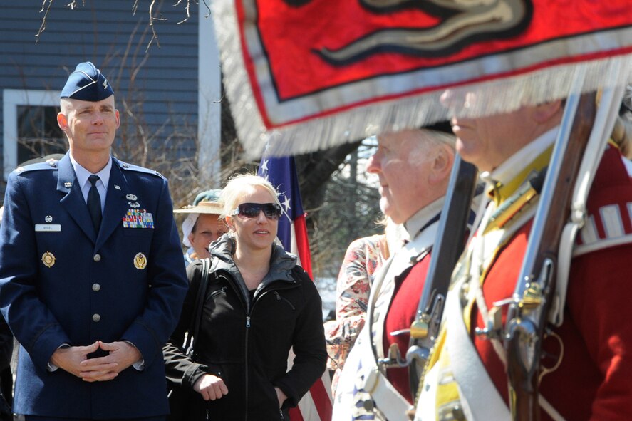 Col. Michael A. Vogel, 66th Air Base Group commander, and his wife Misty, participate in a ceremony at Wilson Park, the site where Bedford Minutemen gathered before marching to Concord April 19, 1775, at the start of the Revolutionary War. The colonel participated in the ceremony that is part of the town of Bedford’s annual Pole Capping event April 11. (U.S. Air Force photo by Linda LaBonte Britt)