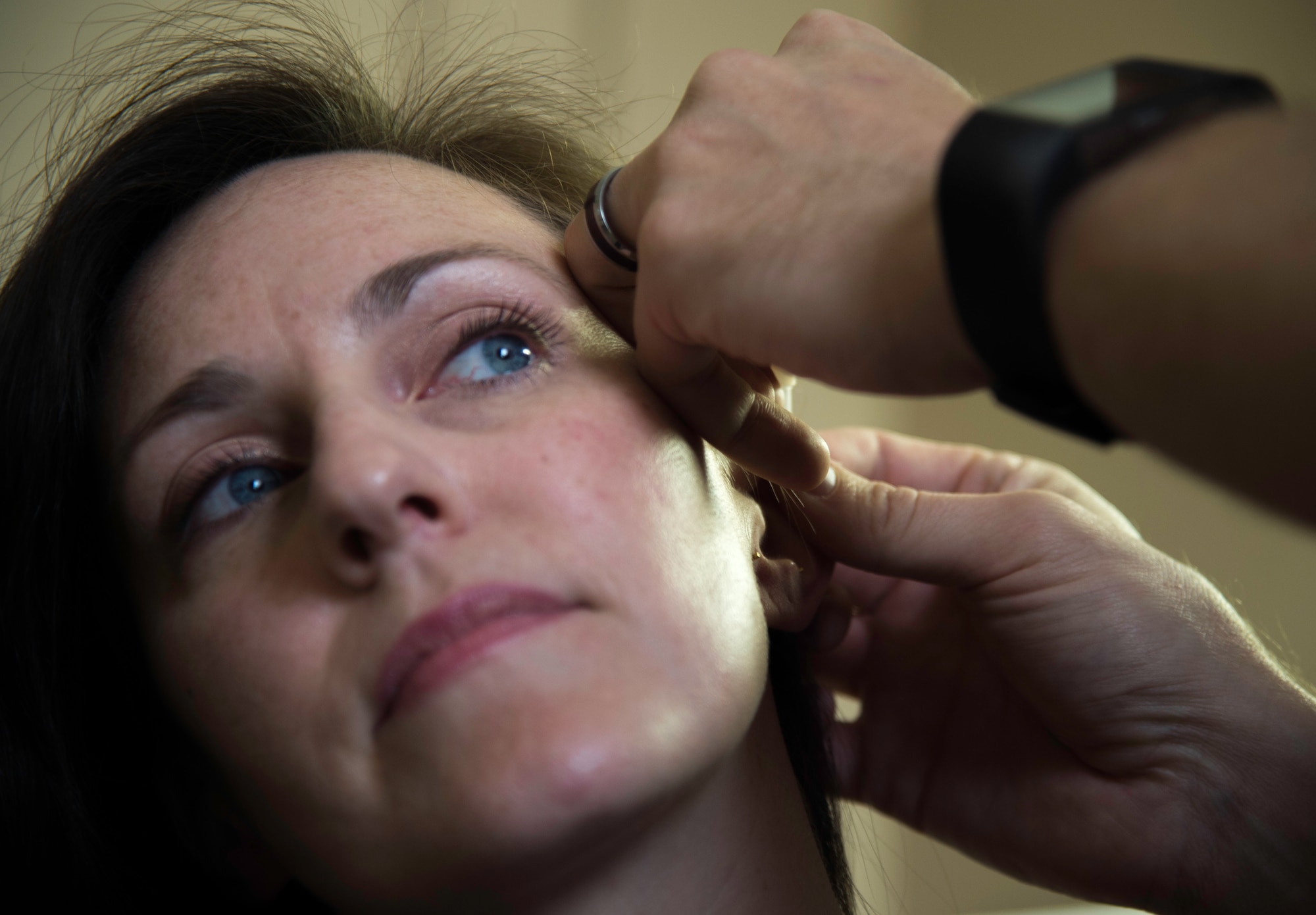 Jennifer Whitaker, acupuncture patient, receives a needle in her ear during an acupuncture treatment session at the Malcom Grow Medical Clinics and Surgery Center, Joint Base Andrews, Md., April 15, 2015. Whitaker was one of approximately 15 to receive acupuncture care as part of a training program to certify Air Force physicians in acupuncture. (U.S. Air Force photo/Airman 1st Class Philip Bryant)