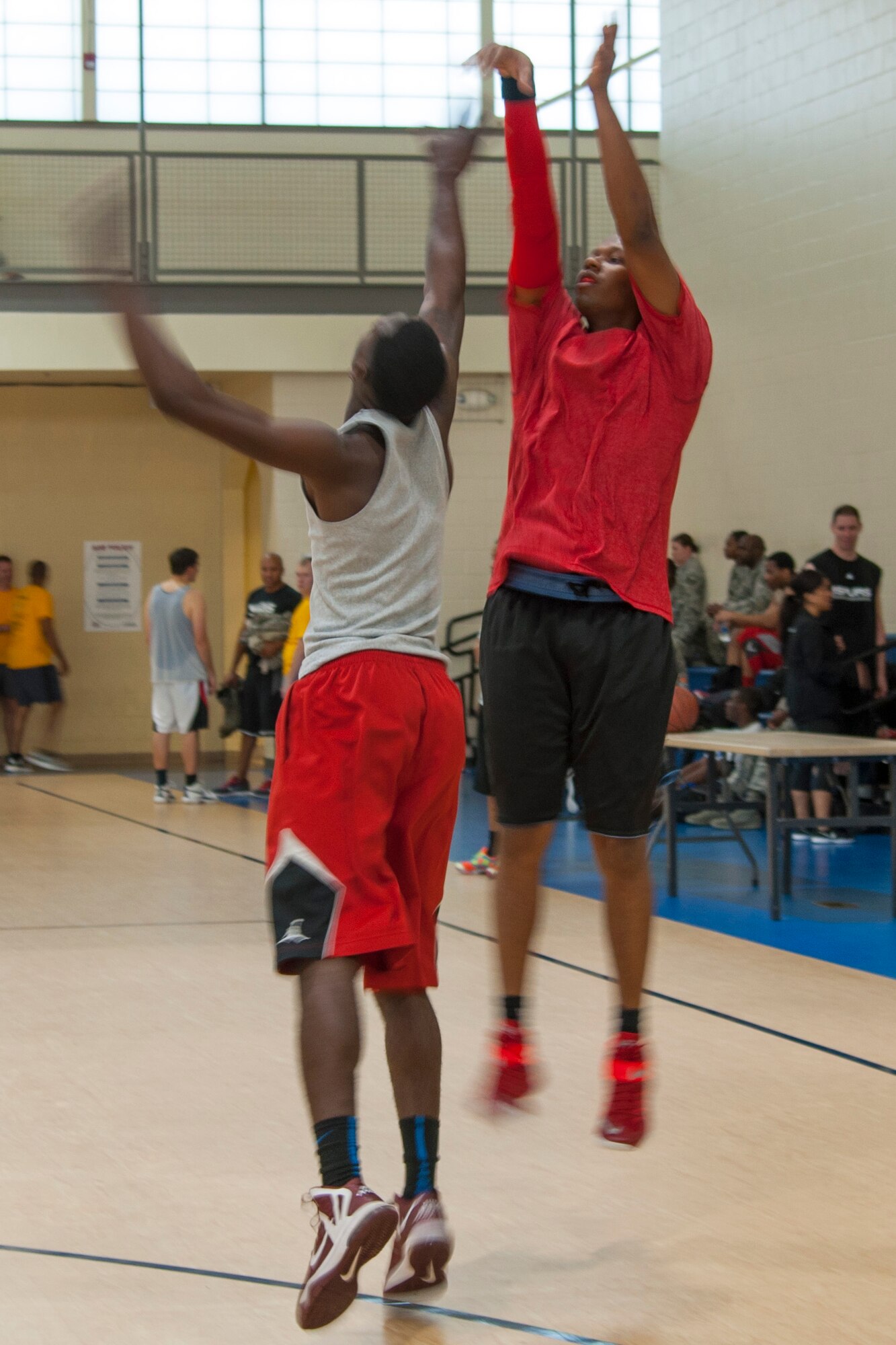 A player makes a jump shot during a basketball tournament at the Senior Airman Bryan Bell Fitness Center on Barksdale Air Force Base, La. on April 11th. The four on four basketball tournament was part of the annual 307th Bomb Wing Family Day. (U.S. Air Force photo by 2nd Lt. Monique Roux/Released)