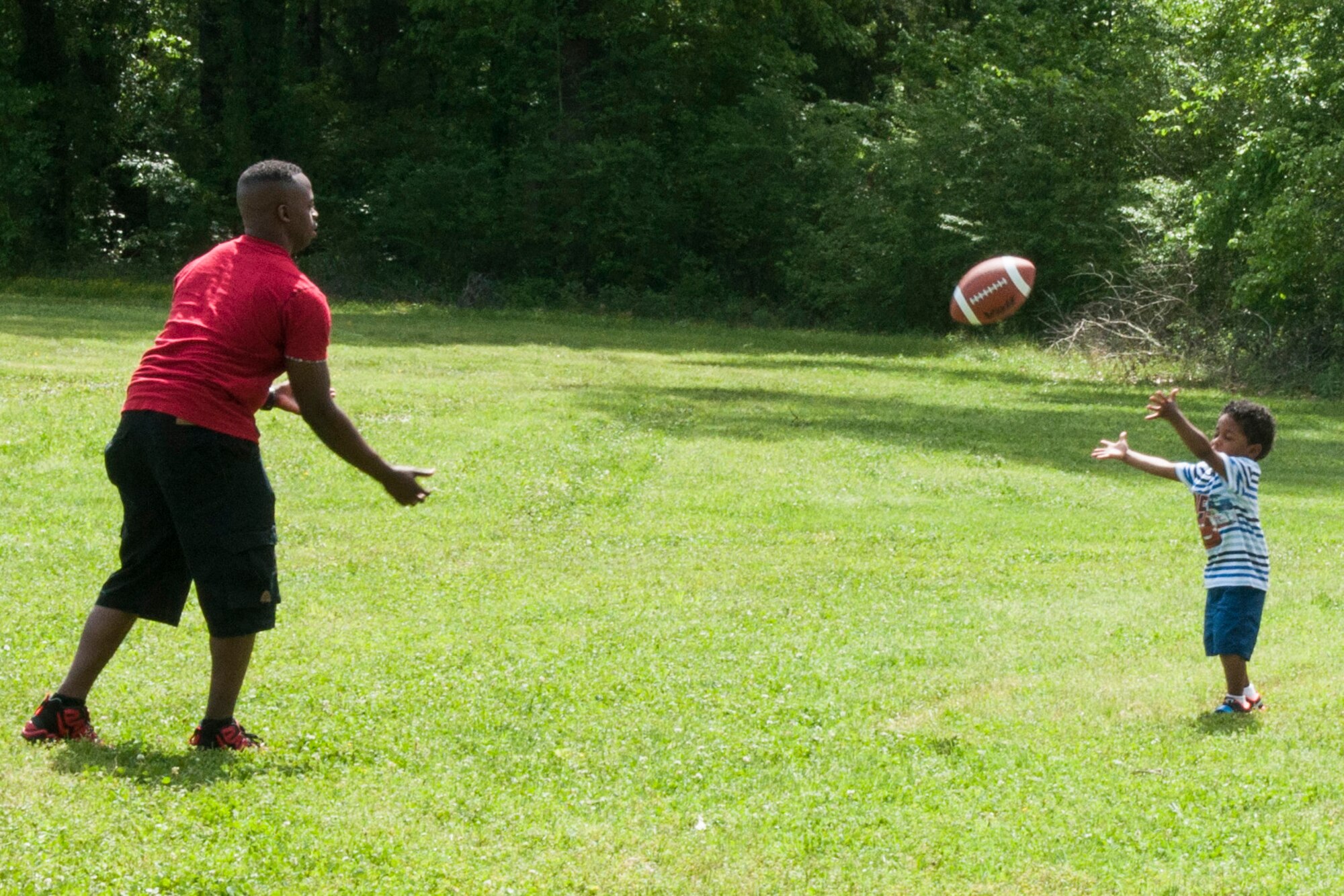 A father and son play catch at Cullen Park on Barksdale Air Force Base, La. The family spent time at the park on April 11th participating in the annual 307th Bomb Wing Family Day. (U.S. Air Force photo by Master Sgt. Dachelle Melville/Released)
