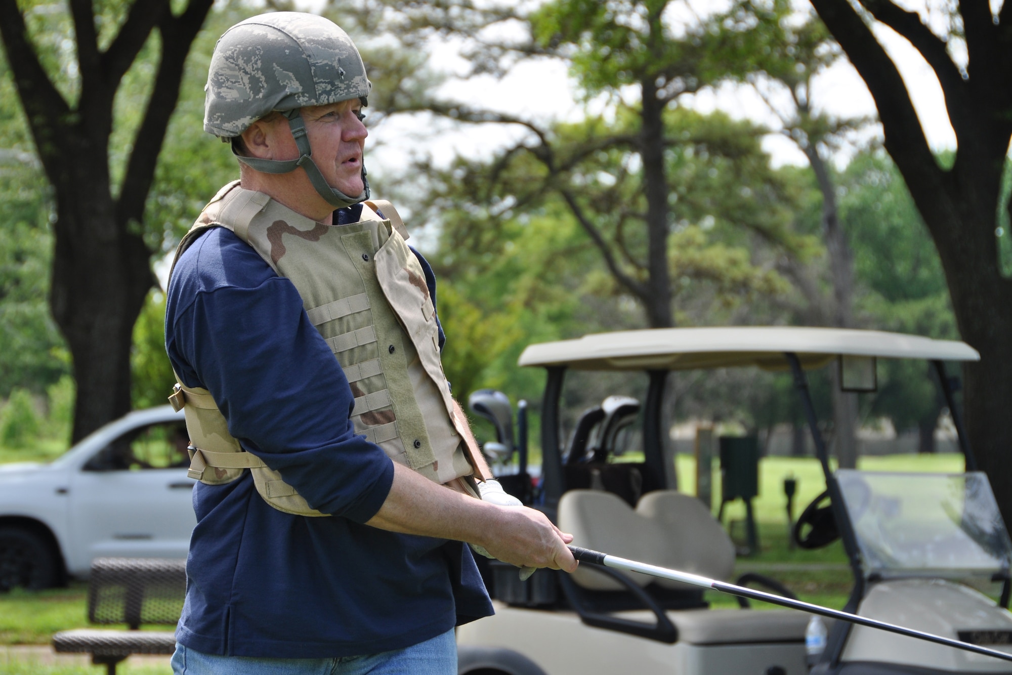 Bruce Cox, the commander for the 307th Bomb Wing watches the path of his golf ball during the Family Day Golf Tournament at Fox Run Golf Course on Barksdale Air Force Base, La. On April 11th teams were challenged with a “combat” hole as part of the tournament to show off their golf skills wearing a helmet and flak vest. (U.S. Air Force photo by Master Sgt. Mary Hinson/Released)