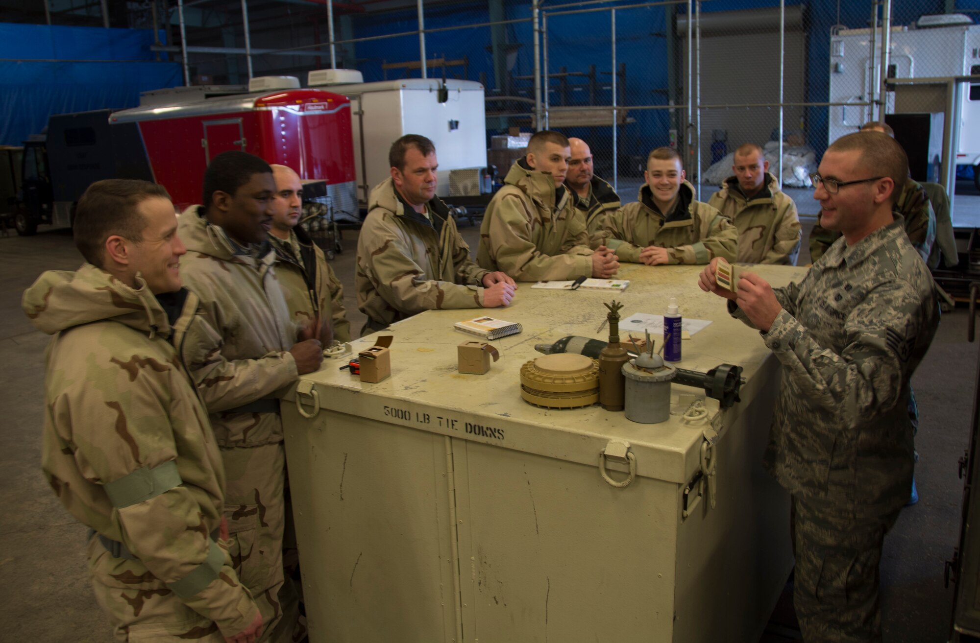 Staff Sgt. Ian King (right), 512th Civil Engineer Squadron, shows color strips that correspond with several types of chemical agents, to fellow 512th Airlift Wing reservists Feb. 7, 2015, at Dover Air Force Base, Del. King led the training that covered detection, protection and avoidance measures during an attack that involves chemical, biological, radiological and nuclear weapons. (U.S. Air Force photo/Staff Sgt. Mercedes Crossland)