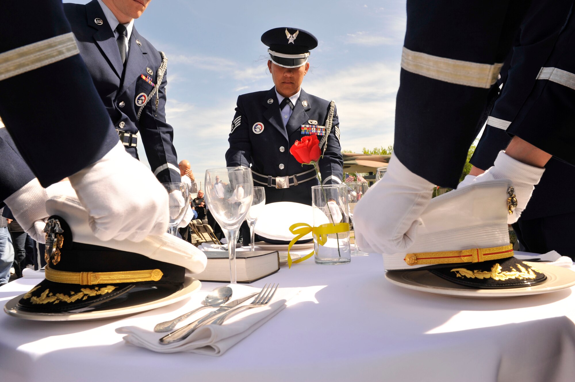 The Little Rock Air Force Base Honor Guard performs a POW/MIA remembrance ceremony April 11, 2015, at the Jacksonville Museum of Military History in Jacksonville, Ark. The table represents Americans who were or are missing from each of the services: Army, Marine Corps, Navy, Air Force, and Coast Guard. (U.S. Air Force photo by Senior Airman Regina Edwards) 