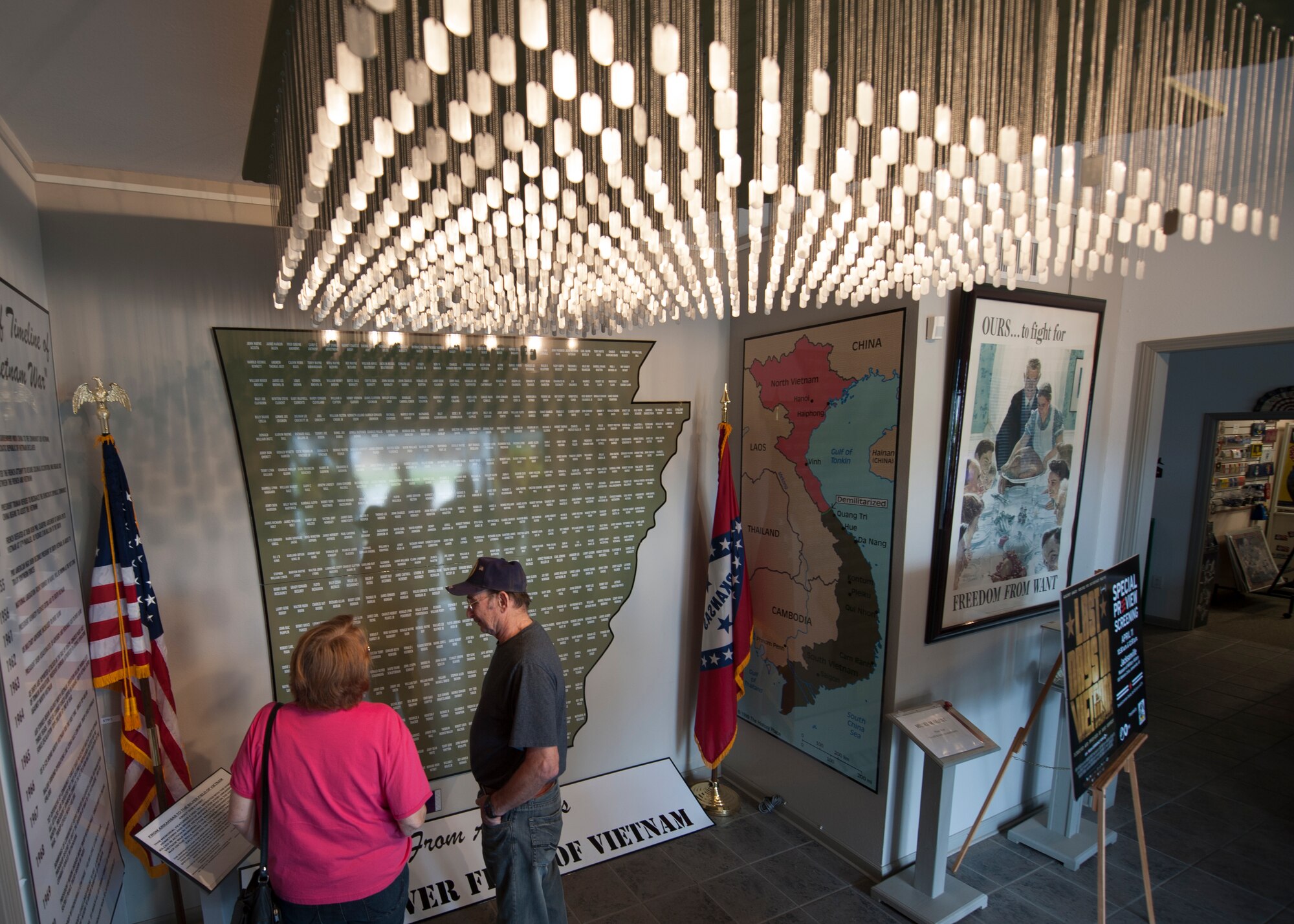Visitors at the Jacksonville Museum of Military History in Jacksonville, Ark., view the names of fallen military members from Arkansas April 11, 2015. More than 500 dog tags hang from the ceiling in correspondence with the names of the fallen on the wall. (U.S. Air Force photo by Airman 1st Class Scott Poe)