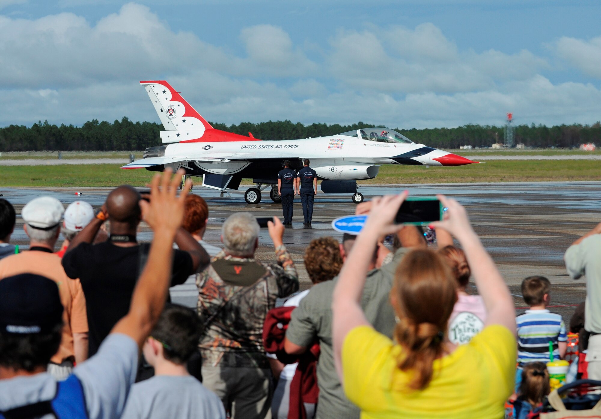 Spectators watch as the U.S. Air Force Thunderbirds taxi to the runway at the Gulf Coast Salute open house and air show April 11, at Tyndall. The air show and open house featured the U.S. Air Force Thunderbirds, the F-22 Raptor demo team, and the U.S. Army Golden Knights. (U.S. Air Force photo by Senior Airman Alex Echols/Released)