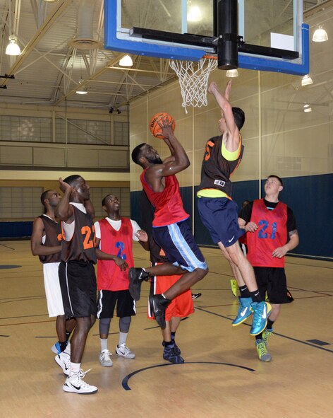 Leon Carswell, 2nd Maintenance Squadron power forward, goes up for a shot as Senior Airman Andres Aguirre, 2nd Aircraft Maintenance Squadron center, defends in the 2015 intramural championship game on Barksdale Air Force Base, La., April 9, 2015. The 2nd Maintenance Squadron upset the previously-undefeated 2nd Aircraft Maintenance Squadron 62-46 to win the championship and finish the season with an 8-2 record. (U.S. Air Force photo/Airman 1st Class Curt Beach)