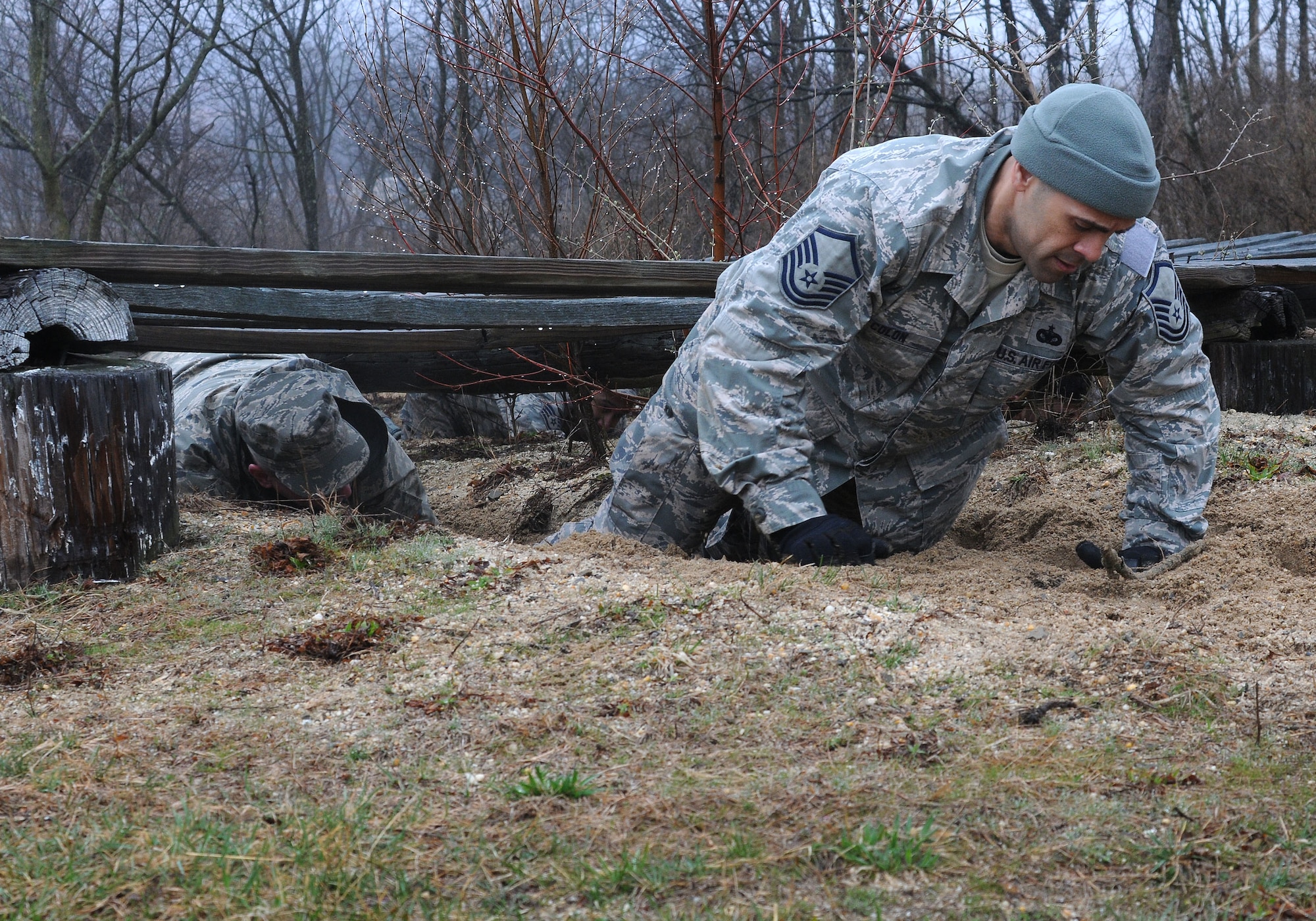 Master Sgt. Miguel Colon, 111th Security Forces Squadron, completes the low-crawl portion of the obstacle course during a four-day team building and skills-training event, April 9 – 12, 2015, at the state’s joint-force training center at Fort Indiantown Gap, Pennsylvania and Gettysburg National Military Park. Nearly 60 Guardsmen from the 111th Attack Wing of Horsham Air Guard Station participated in the super drill. (U.S. Air National Guard photo/Released)