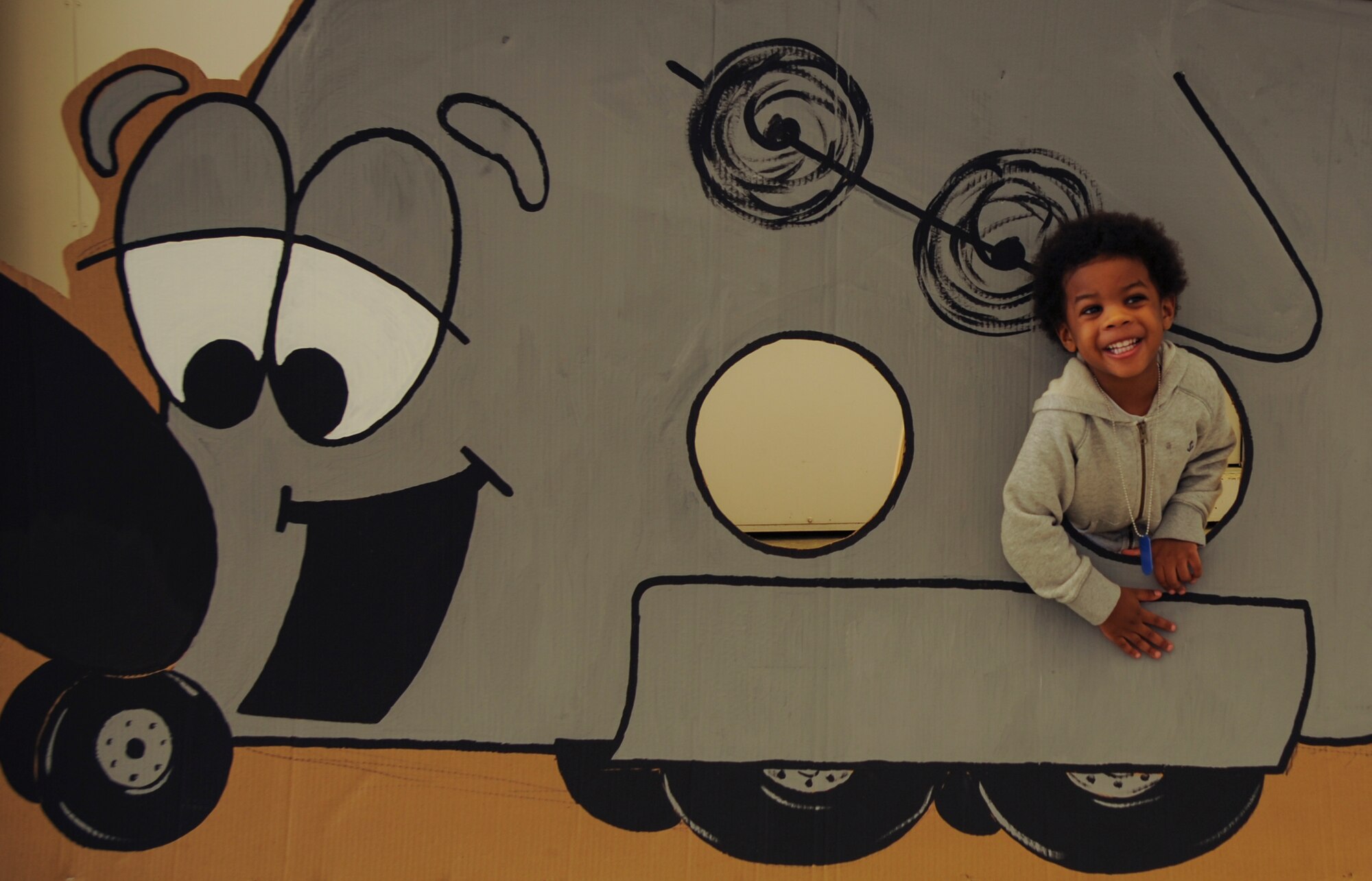Braylon poses for a photo with a C-130 cutout April 11, 2015, at Little Rock Air Force Base, Ark. Approximately 150 children attended the Kids Understanding Deployment Operations event.  (U.S. Air Force photo by Airman 1st Class Harry Brexel)