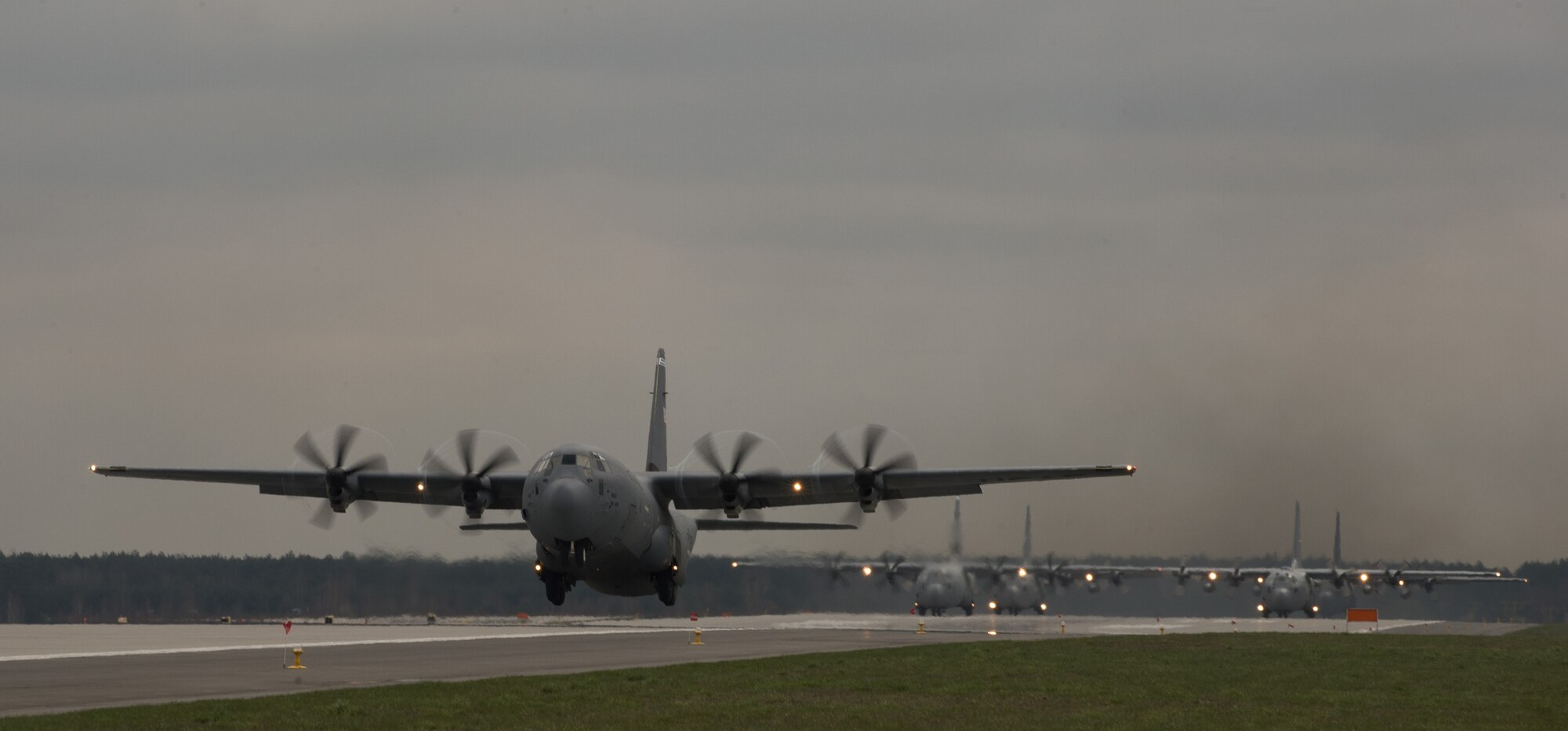 A C-130J Super Hercules assigned to the 37th Airlift Squadron, is the first to take-off as part of a five-ship formation at Powidz Air Base, Poland, April 15, 2015. C-130s from Ramstein Air Base, Germany and Peterson Air Force Base, Colo., flew alongside the Polish air force during training at Powidz. (U.S. Air Force photo/Senior Airman Jonathan Stefanko)
