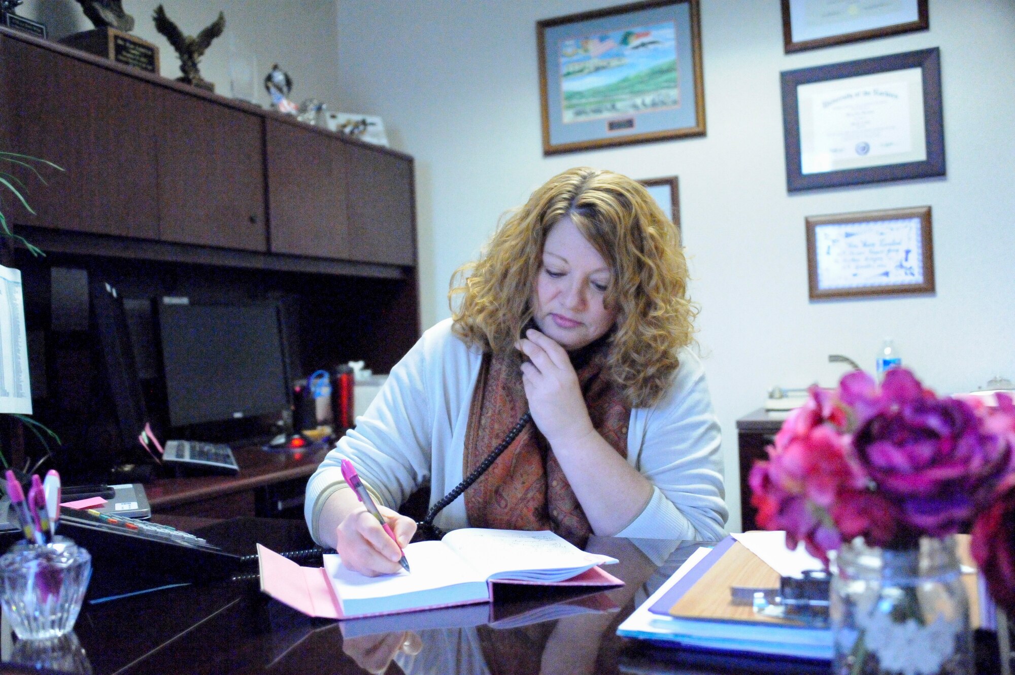 Mary Kierstead, Joint Base McGuire-Dix-Lakehurst Sexual Assault Response Coordinator takes notes during a phone call. In addition to her role as SARC, Kierstead also functions as case manager for every assault victim personally. (U.S. Air Force photo by Pascual Flores/released)