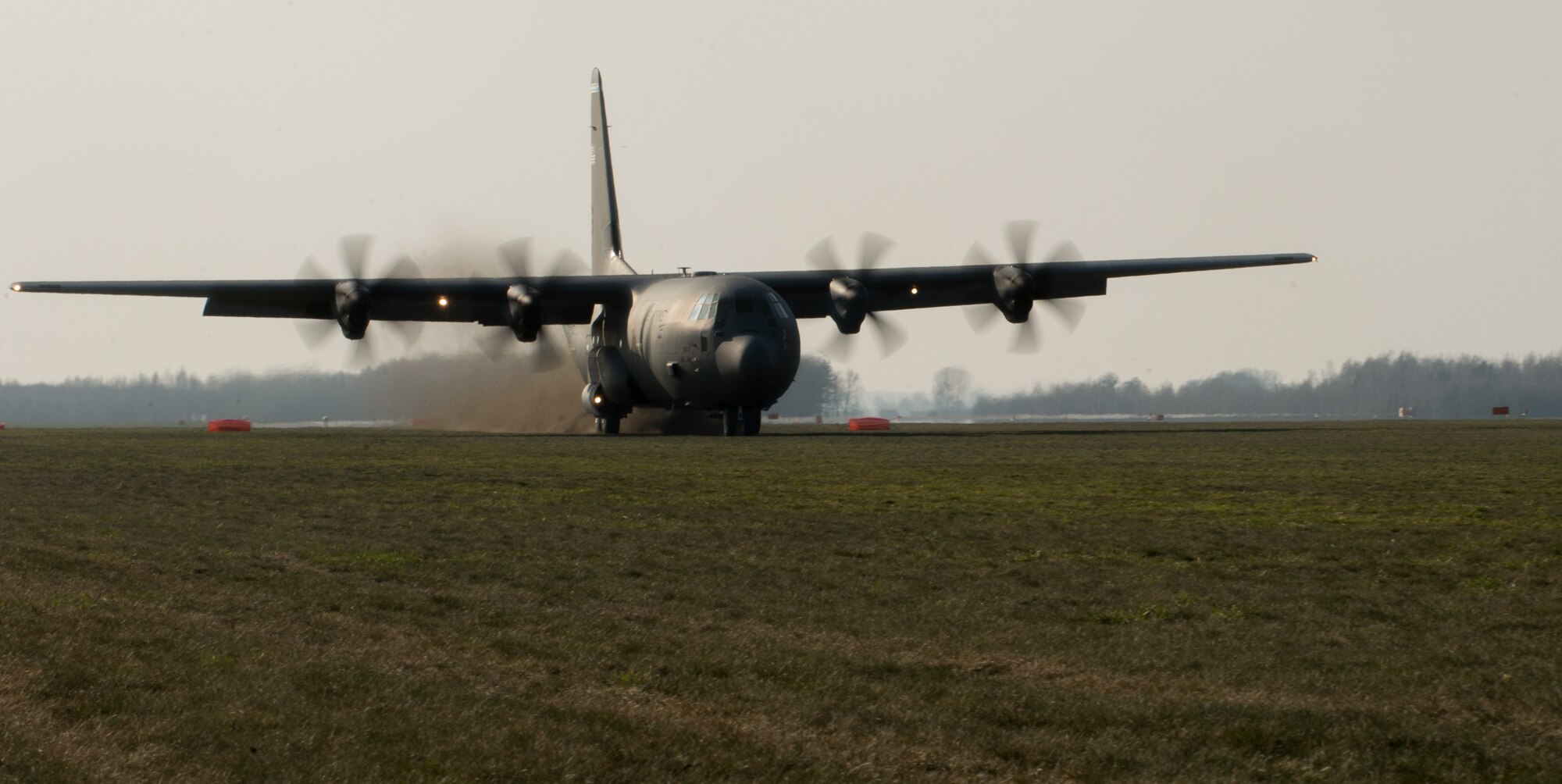 A C-130J Super Hercules assigned to the 37th Airlift Squadron performs a grass-strip landing at Powidz Air Base, Poland, April 10, 2015. U.S. military members traveled to Powidz as part of a flying training deployment where they trained alongside their Polish counterparts. (U.S. Air Force photo/Senior Airman Jonathan Stefanko)