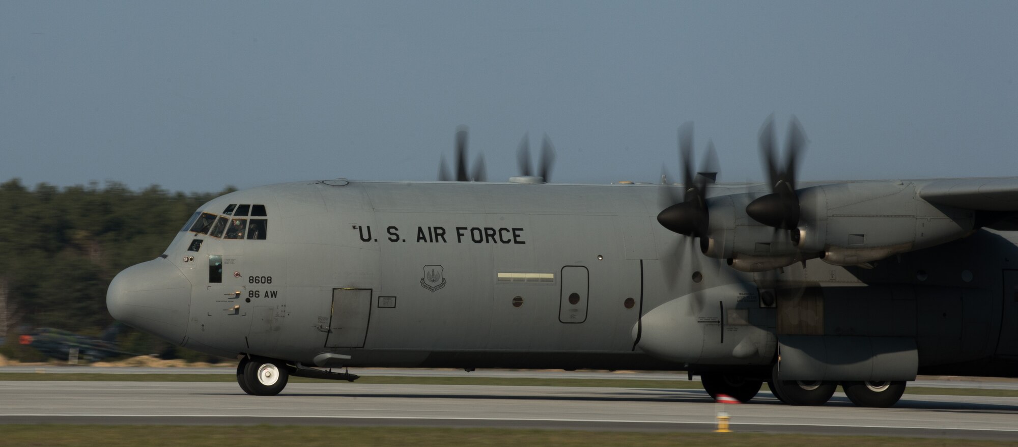 A C-130J Super Hercules assigned to the 37th Airlift Squadron lands at Powiz Air Base, Poland, April 10, 2015. Approximately 135 active duty and reserve U.S. Armed Forces arrived to Powidz to work alongside their Polish counterparts. The goal of the training is to reassure European allies of the U.S.’s commitment to peace and regional security. (U.S. Air Force photo/Senior Airman Jonathan Stefanko)