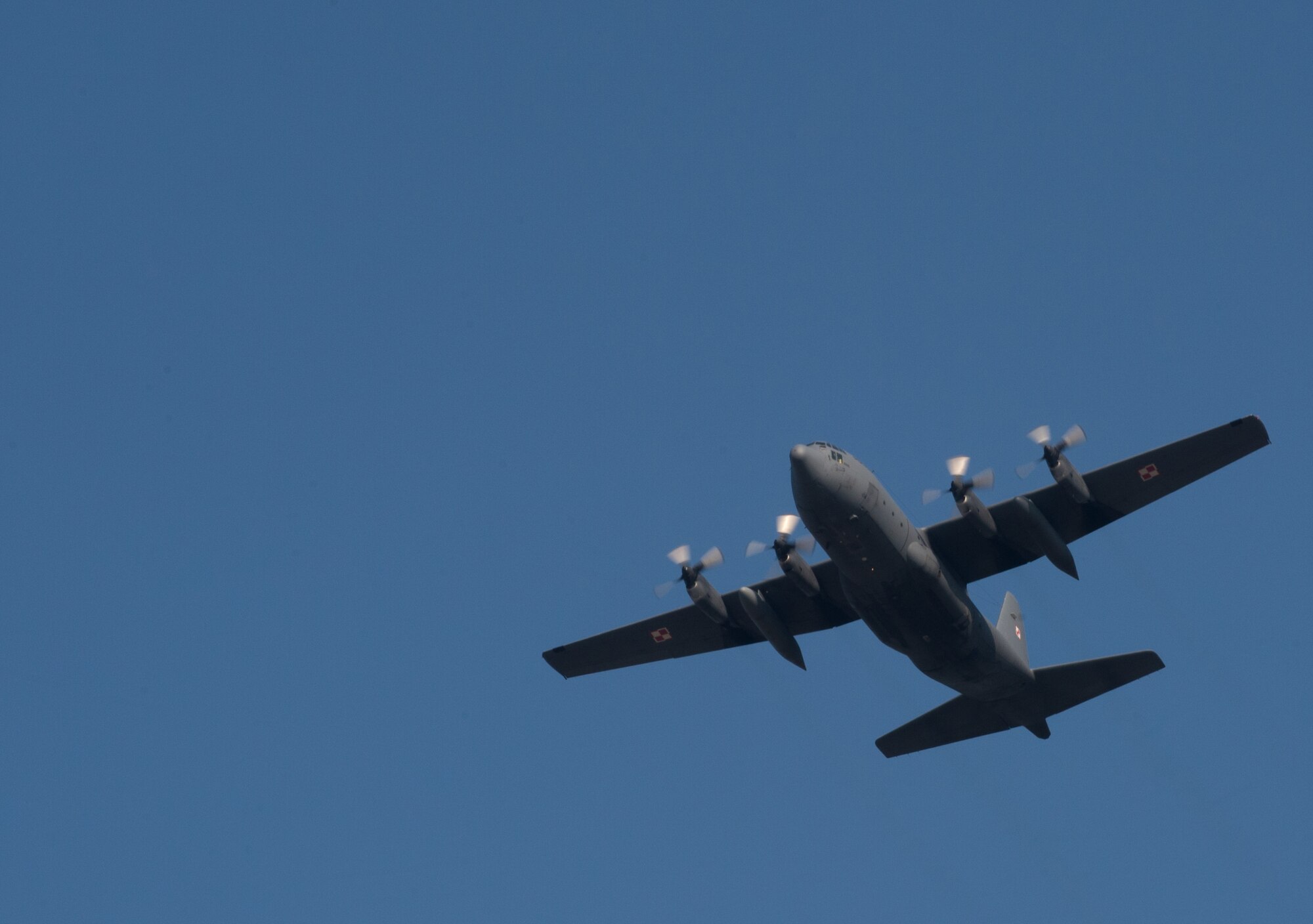 A Polish C-130E legacy model flies above Powidz Air Base, Poland, April 10, 2015. Polish Armed Forces trained alongside U.S. military members during a flying training deployment to Powidz, Poland. The goal of the deployment was to build and improve partnership with the Polish air force as well as interoperability for future operations. The training started on April 8 and will conclude April 17. (U.S. Air Force photo/Senior Airman Jonathan Stefanko)