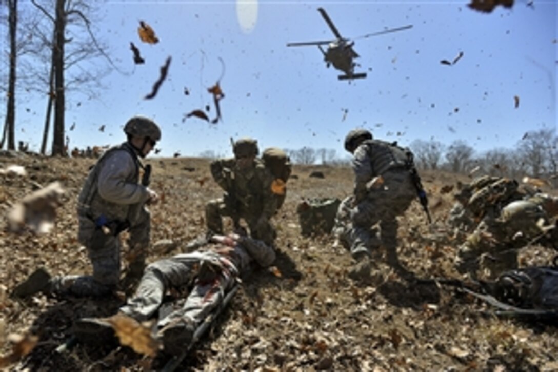 An HH-60 Pave Hawk helicopter lands to pick up "wounded" airmen from the casualty collection point during training on Camp Smith, N.Y., April 12, 2015. The airmen are assigned to the New York National Guard's 106th Security Forces Squadron.