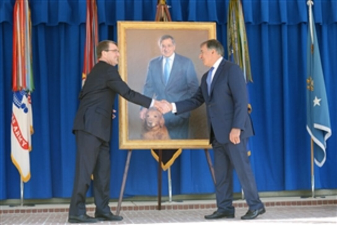 Defense Secretary Ash Carter, left, shakes hands with former Defense Secretary Leon E. Panetta at the portrait unveiling of Panetta at the Pentagon, April 16, 2015. 