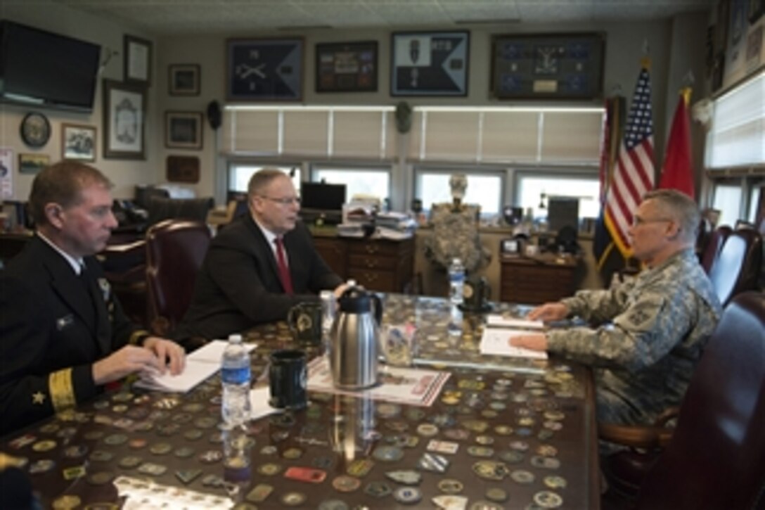 Deputy Defense Secretary Bob Work, center, meets with Army Maj. Gen. Paul LaCamera, commanding general, 4th Infantry Division, to discuss matters of importance during a visit on Fort Carson, Colo., April 15, 2015.