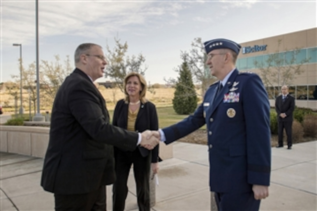 Deputy Defense Secretary Bob Work, left, shakes hands with Air Force Gen. John Hyten, commander, Air Force Space Command, and Secretary of the Air Force Deborah Lee James, upon arrival at the Scitor Complex to attend and speak at the Space Symposium in Colorado Springs, Colo., April, 15, 2015.