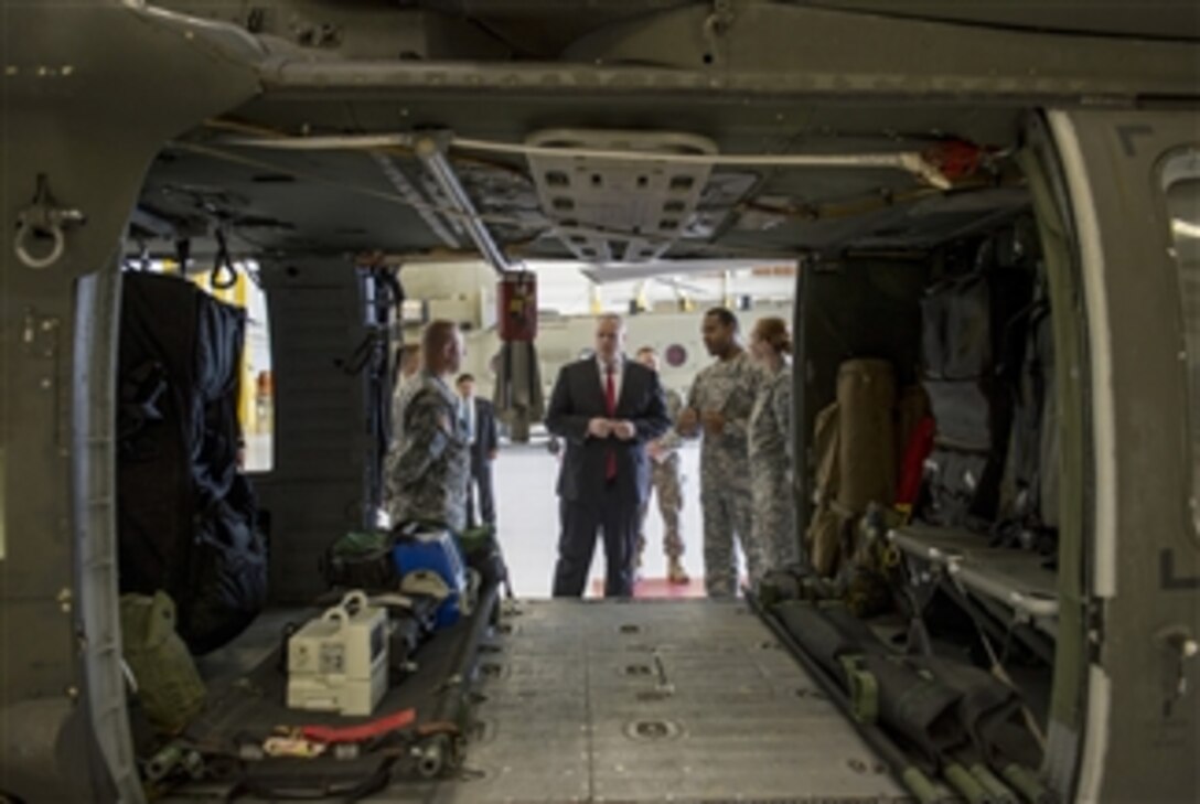 Deputy Secretary of Defense Bob Work speaks with soldiers from the 4th Combat Aviation Brigade as he tours a maintenance facility on Fort Carson, Colo., April, 15, 2015.