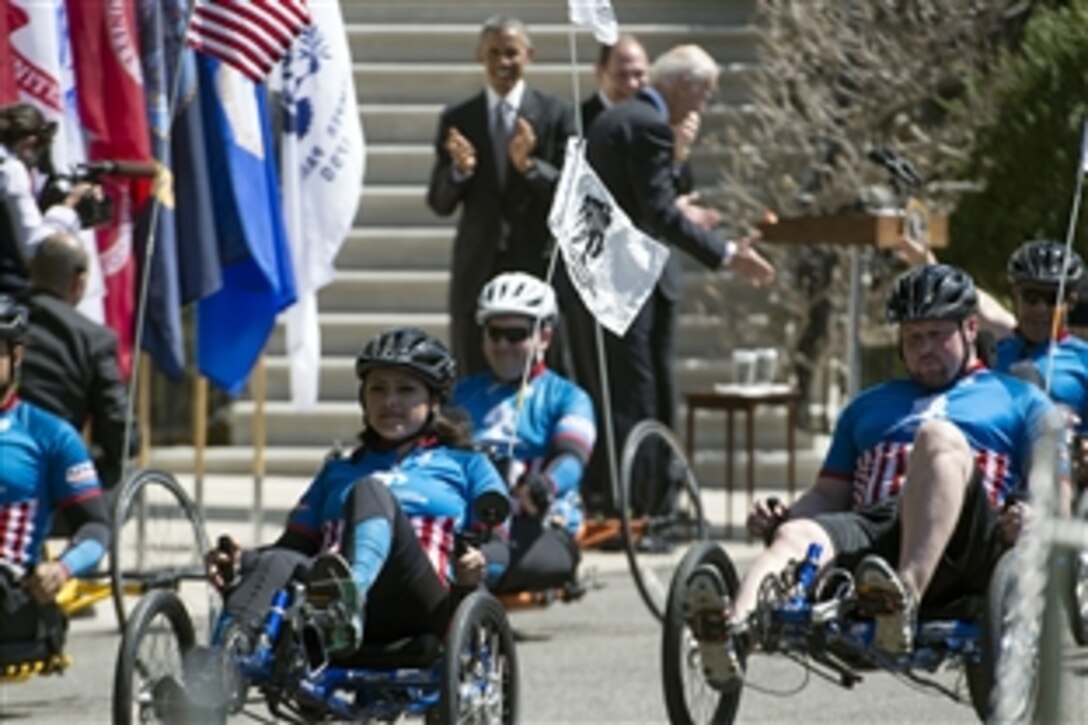 President Barack Obama applauds wounded warrior cyclists at the White House in Washington, D.C., April 16, 2015. Wounded military veterans from each service rode their cycles around the White House south lawn to raise awareness for wounded veterans as part of the annual Wounded Warrior Project's soldier ride. 