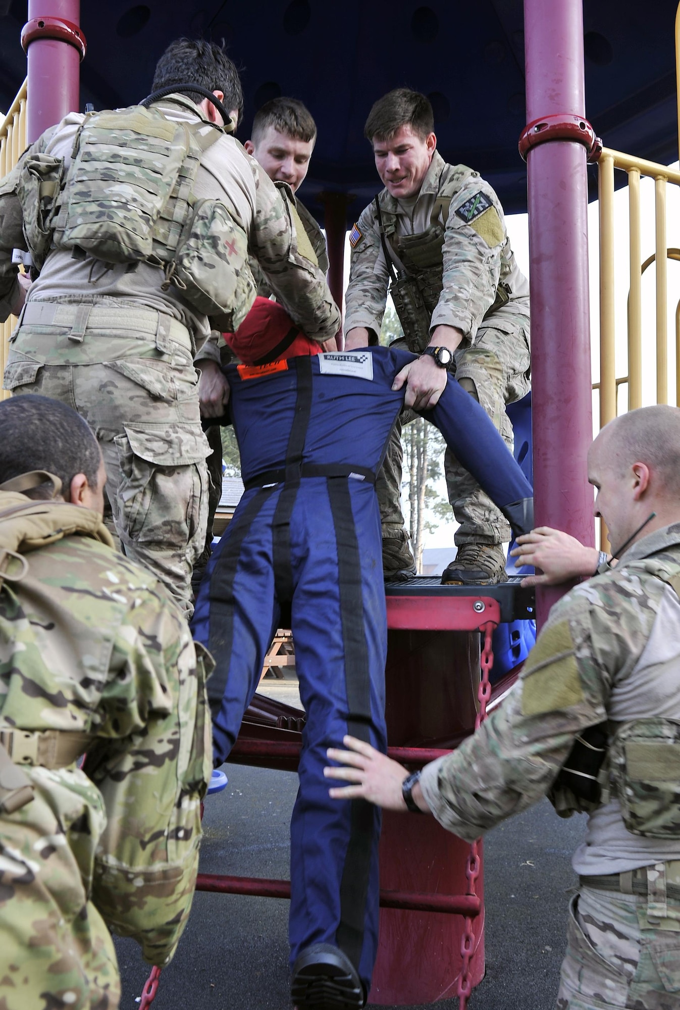Members of the 321st Special Tactics Squadron assist their teammates in lifting Mr. Hurt, a dummy, during the Monster Mash April 10, 2015, on RAF Mildenhall, England. The Monster Mash is an event composed of a variety of team building challenges, created to prepare Airmen for real-life scenarios. (U.S. Air Force photo by Airman 1st Class Kyla Gifford)