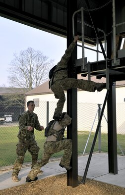 An Air Commando from the 321st Special Tactics Squadron climbs across a “lava” pit during the Monster Mash April 10, 2015 on RAF Mildenhall, England. A Monster Mash is a long-standing special tactics tradition which combines event designed to test strength, stamina and teamwork skills. 