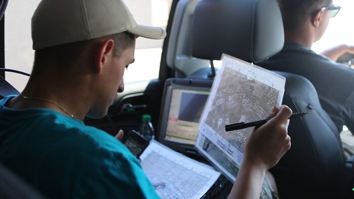 Cpl. Martin Quevedo-Chirinos, a joint fires observer with 1st Air Naval Gunfire Liaison Company, reviews gridded reference graphics of Lake Havasu City, Arizona, during simulated close air support training April 12-13, 2015. The training allowed Marines to receive valuable training with various types of equipment.